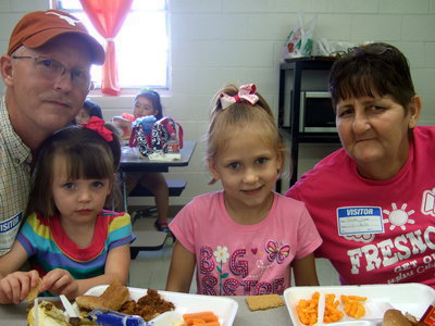 Image: Kelvin Loper (Grandpa), Baylee Brewster, Lillie Brewster (Pre-K4) and Gwen Loper celebrating Grandparents Day.