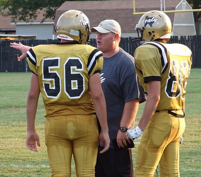Image: Austin Crawford(56) and Kyle Machovich(88) take direction from Coach Gansky.