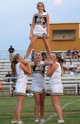 Image: Karley Nelson gets a boost from fellow cheerleaders Hannah Haight, Annie Perry and Sydney Weeks.