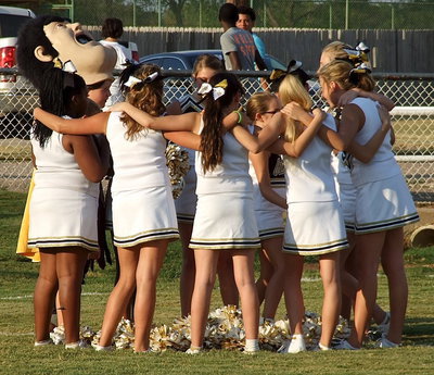 Image: The Italy JH cheerleaders huddle up and surround Karley Nelson who gets krunk before the game.