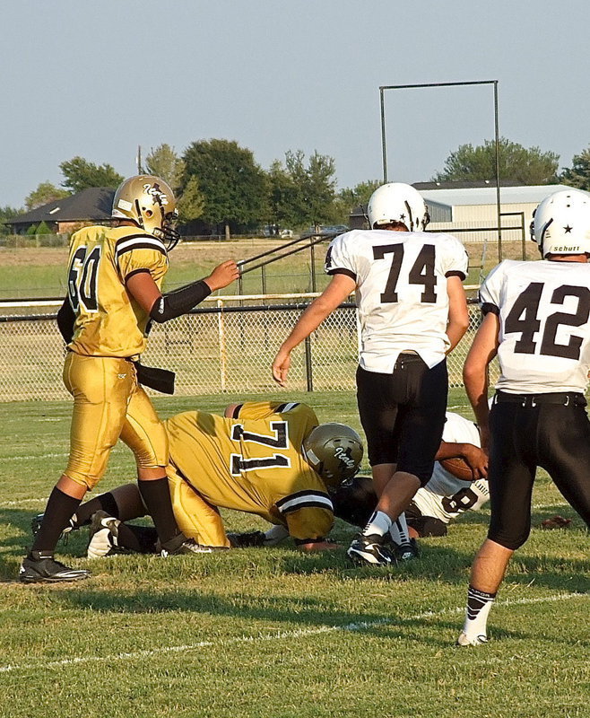 Image: Aaron Pittmon(71) explodes into the Tiger backfield and makes a tackle for a loss.