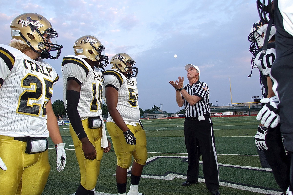 Image: Gladiator captains Shadrach Newman(25), TaMarcus Sheppard(10) and Darol Mayberry(58) await the result of the ceremonial coin toss.