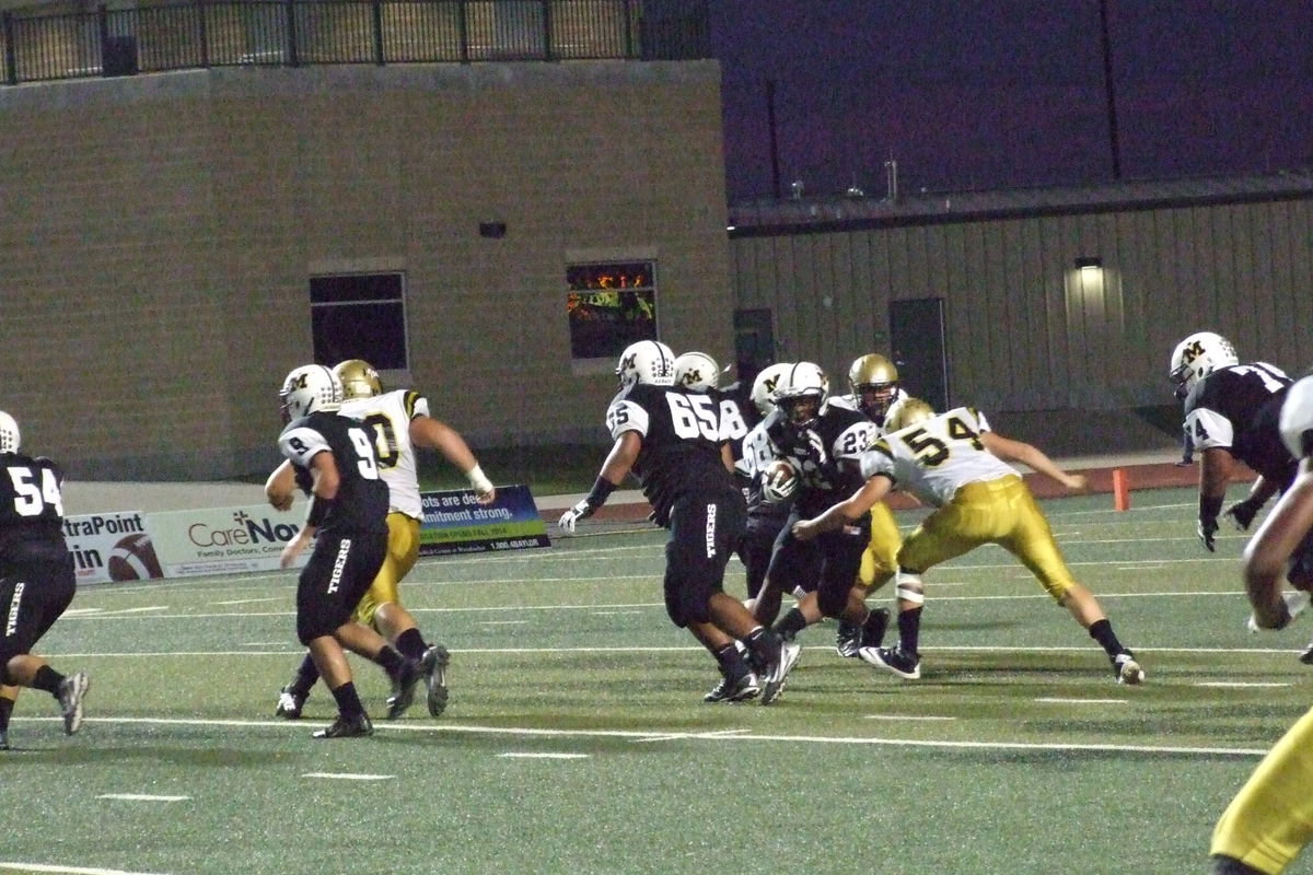 Image: Gladiator senior defensive end Bailey Walton(54) unloads on a Malakoff runner to jar the ball loose for the second of two caused fumbles by Walton in the game.