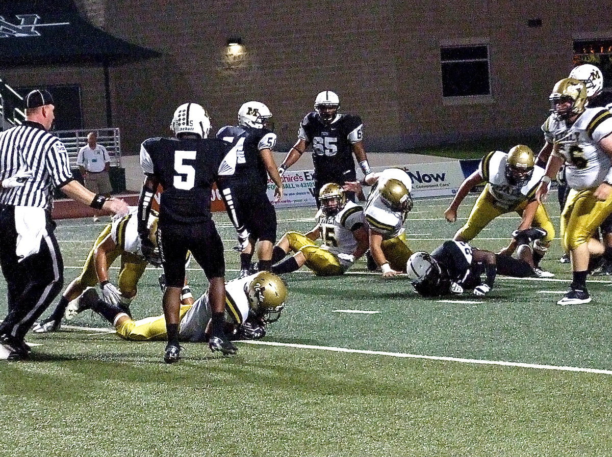 Image: Italy safety Ryan Connor(21) recovers the fumble before Malakoff can get to it.