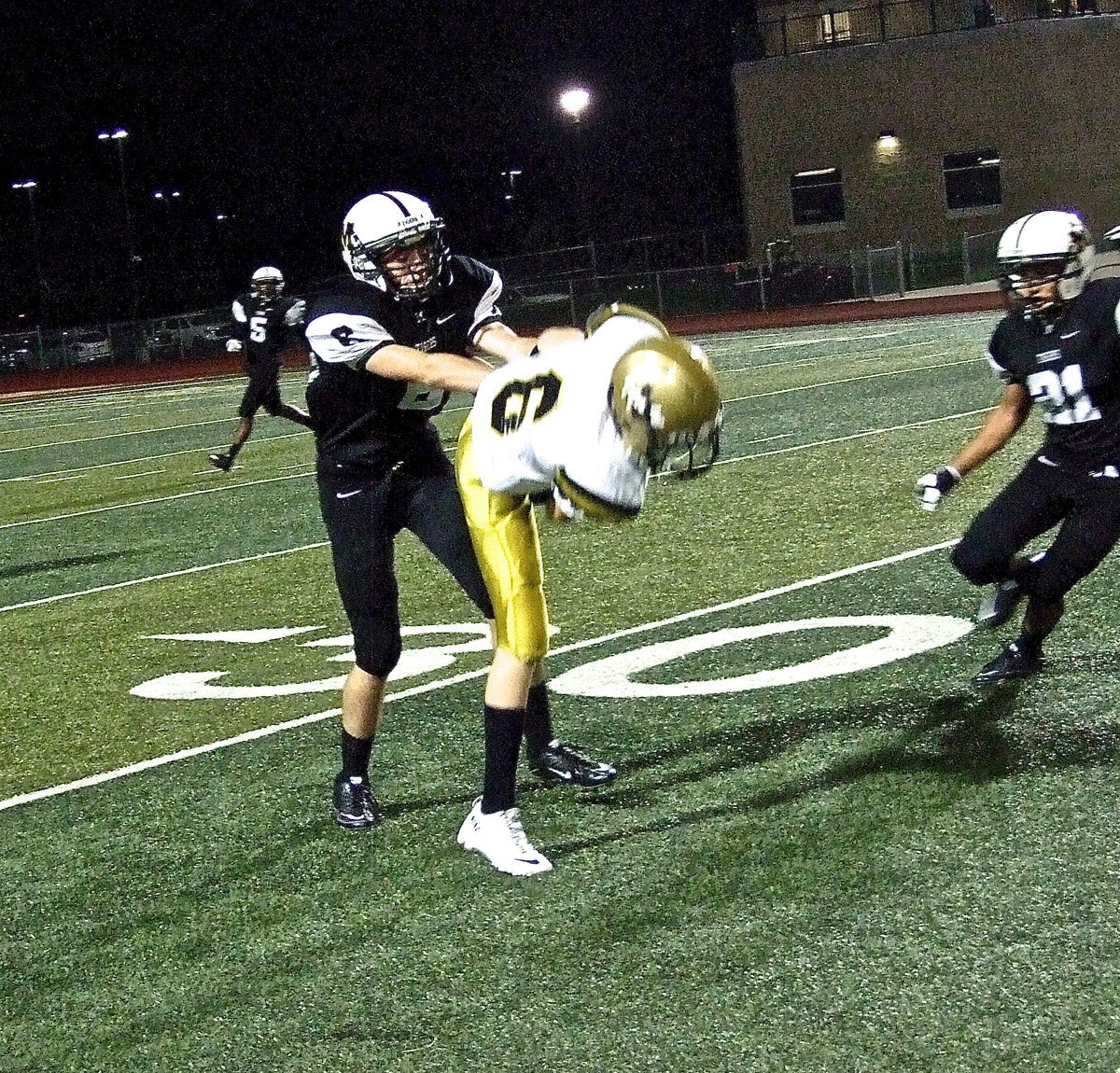 Image: Gladiator sophomore receiver Clayton Miller(6) hauls in a pass and hangs on to the ball after absorbing a hard shove from a Tiger defender. Miller gained 6-yards on the play.