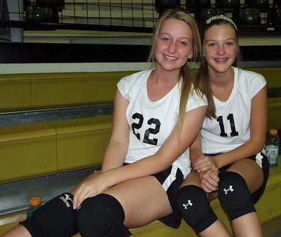 Image: Rachel Huskins(22) and Kirsten Viator(11) chill at the top of the bleachers before their game.