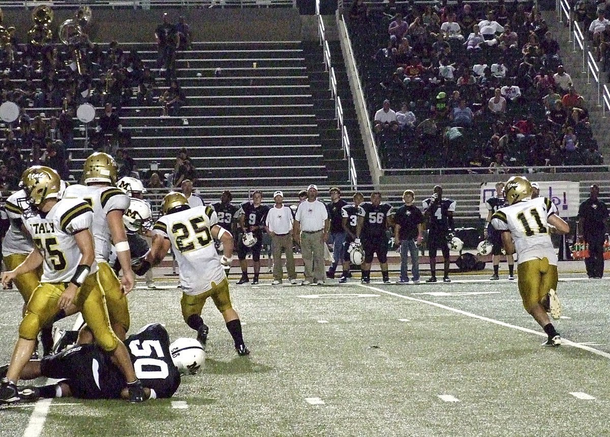 Image: Italy quarterback Tyler Anderson(11) rolls out while Cody Medrano(75), Zain Byers(50) and Shad Newman(25) block up front.