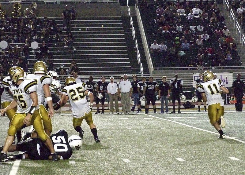 Image: Italy quarterback Tyler Anderson(11) rolls out while Cody Medrano(75), Zain Byers(50) and Shad Newman(25) block up front.