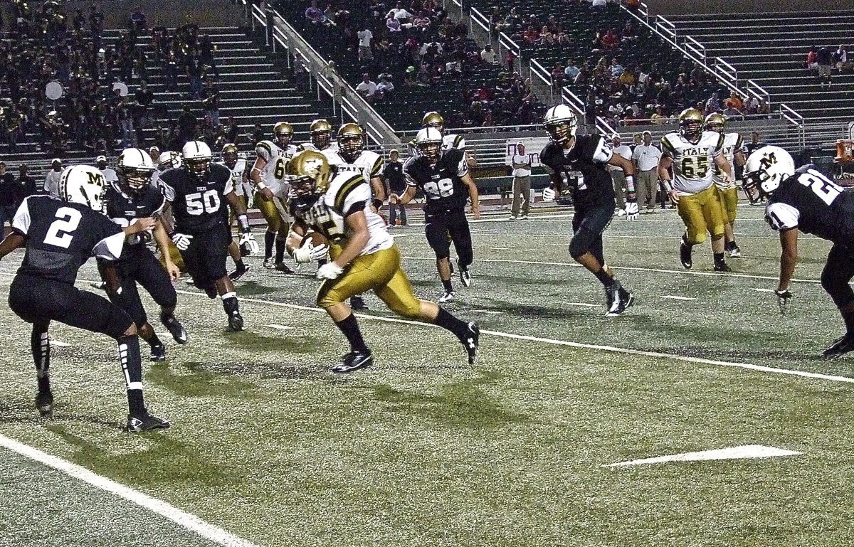 Image: Shad Newman(25) barrels forward against the Tiger defense.