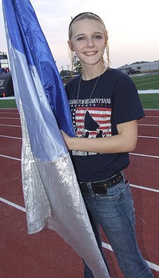 Image: Color Guard member Paige Cunningham practices for the halftime show.
