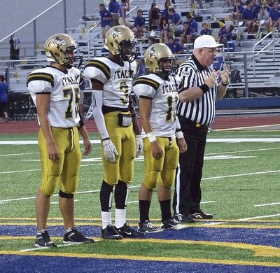 Image: Gladiator captains Cody Medrano(75), Trevon Robertson(3) and Tyler Anderson(11) have the opening kickoff deferred by Sunnyvale.