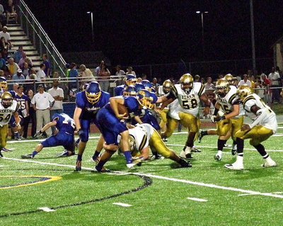 Image: Defensive end Zain Byers(50) tackles Sunnyvale’s quarterback with defensive buddies Darol Mayberry(58), Shad Newman(25) and TaMarcus Sheppard(11) backing Byers up.