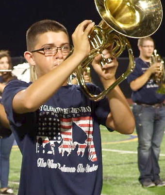 Image: Eli Garcia plays “Taps” during an emotional tribute during the Gladiator Regiment Marching Band and Color Guard’s halftime presentation themed, “The War Between The States.”