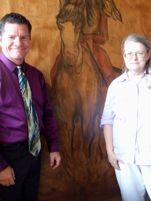 Image: Raymond Mosley and Freeda Arnold are the owners of Things Beautiful standing in front of one of Freeda’s painting.