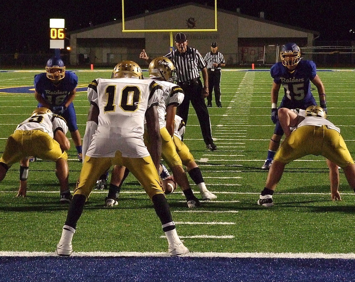 Image: TaMarcus Sheppard(10) has the best seat in the house as Tyler Anderson(11) calls the cadence.