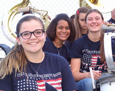 Image: Reagan Adams, Alex Minton and Whitney Wolaver take a break from jamming in the stands.