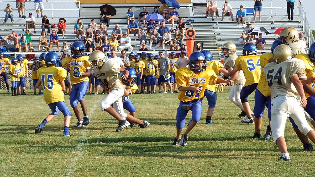 Image: Jacob Wiser(74) drags a blocker with him as he sacks the Sunnyvale quarterback again.