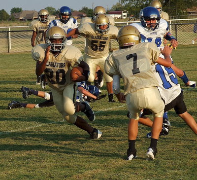 Image: Kendrick Norwood(20) finds running room around teammate Gary Escamilla(7) who shields a tackler.