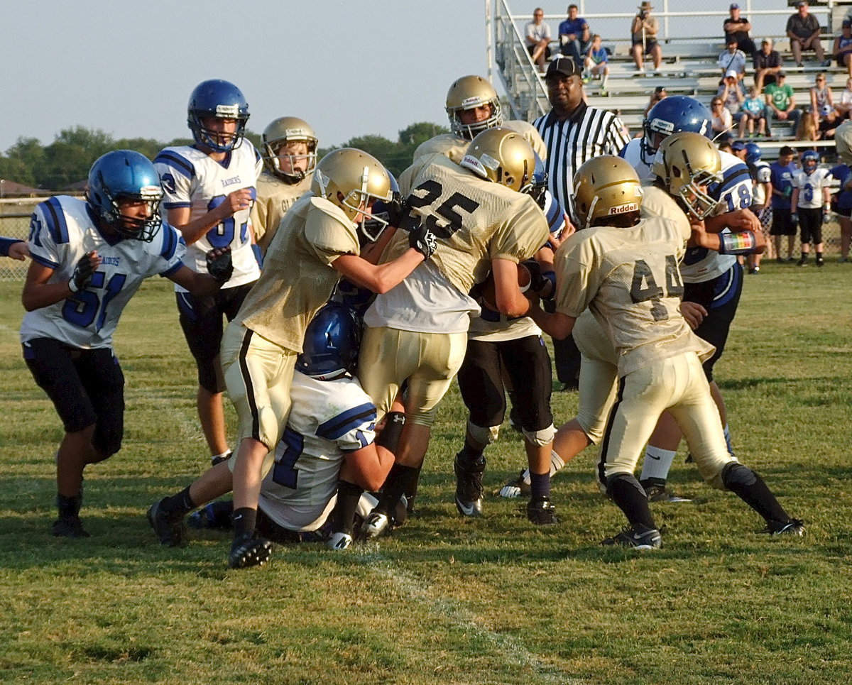 Image: Kyle Tindol(25) fights his way for more yards with help from Garrett Janek(8) who gives Tindol a nudge from behind and from Ben Latimer(44) who tries to separate Tindol from a Sunnyvale tackler.