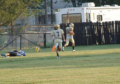 Image: Kyle Tindol(25) goes the distance for his first touchdown wearing Gladiator Gold as teammate Gary Escamilla(7) hustles down to celebrate with his fellow 8th Grader.