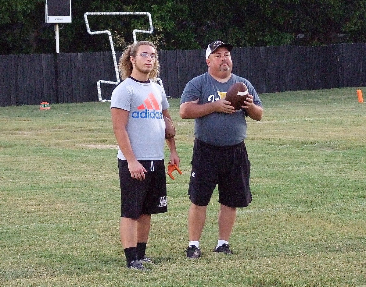 Image: Senior Gladiator Shadrach Newman offers assistance to the underclassmen as coach Wayne Rowe recalls his glory days.