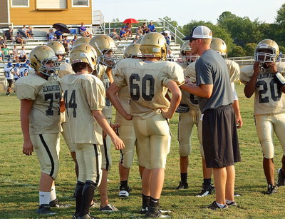 Image: Coach Jon Cady huddles his 8th grade Gladiators with the game intensified.