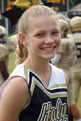 Image: Cheerleader Taylor Boyd brightens up the Italy sideline with a smile under a cloudy day.