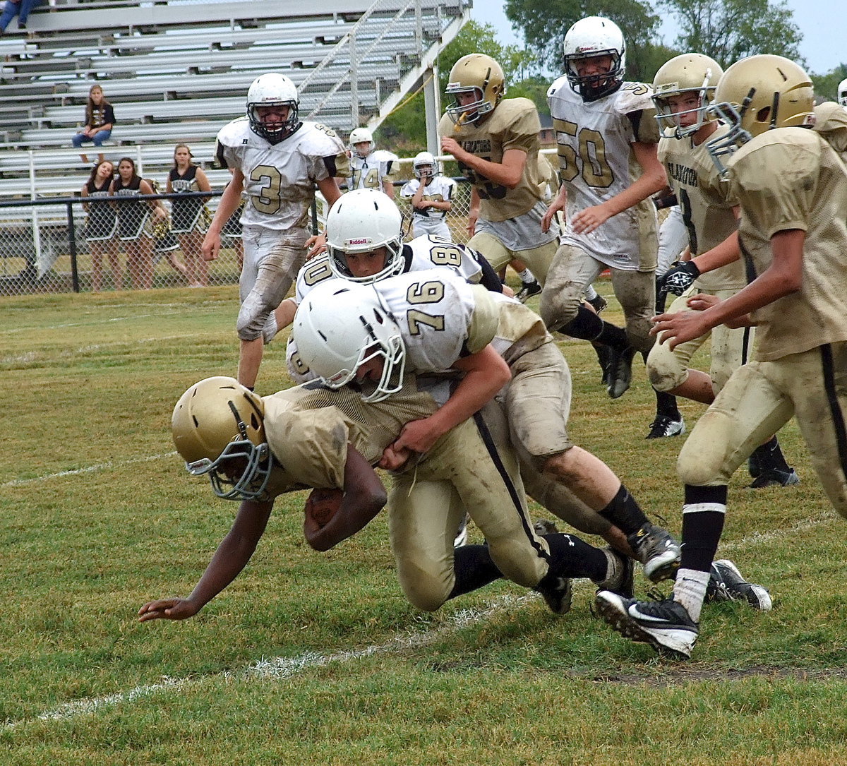 Image: Kendrick Norwood(20) is tackled by a Hubbard defender but not before Norwood picked up several yards.