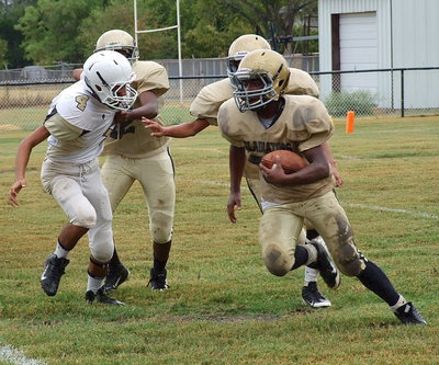 Image: Anthony Lusk(72) and Tylan Wallace(10) clear room for Kendrick Norwood(20) to escape the backfield.