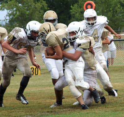 Image: Italy 7th grader Jonathan Salas(22) drags Jaguar tackles toward the endzone.
