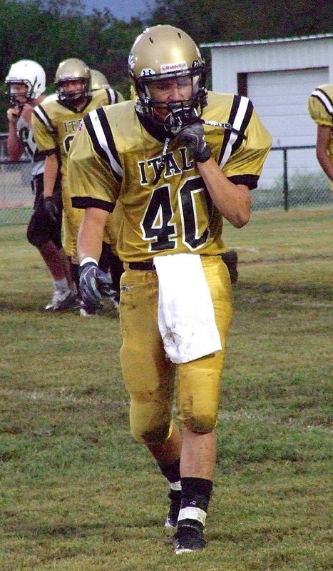 Image: Colton Grant(40) returns to the sideline after the JV game gets delayed by lightning just before halftime.