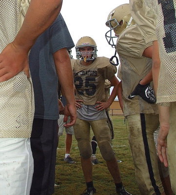 Image: Kyle Tindol(25) huddles with his teammates.