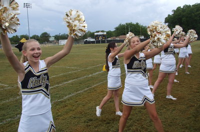 Image: Taylor Boyd, Madison Galvan, Maegan Connor and the rest of their cheer mates pull out their secret weapons to shake things up on the sideline.