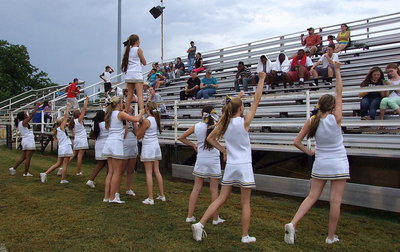 Image: The cheerleaders perform a stunt for the fans.
