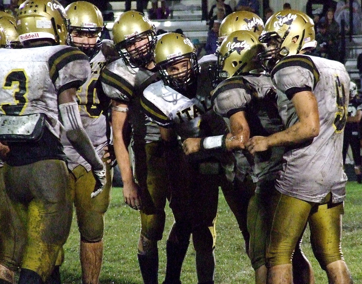 Image: When the QB speaks, teammates listen: Italy Gladiator senior quarterback Tyler Anderson(11) relays the play into the huddle with Italy’s offense looking for answers in the second half against Hubbard.