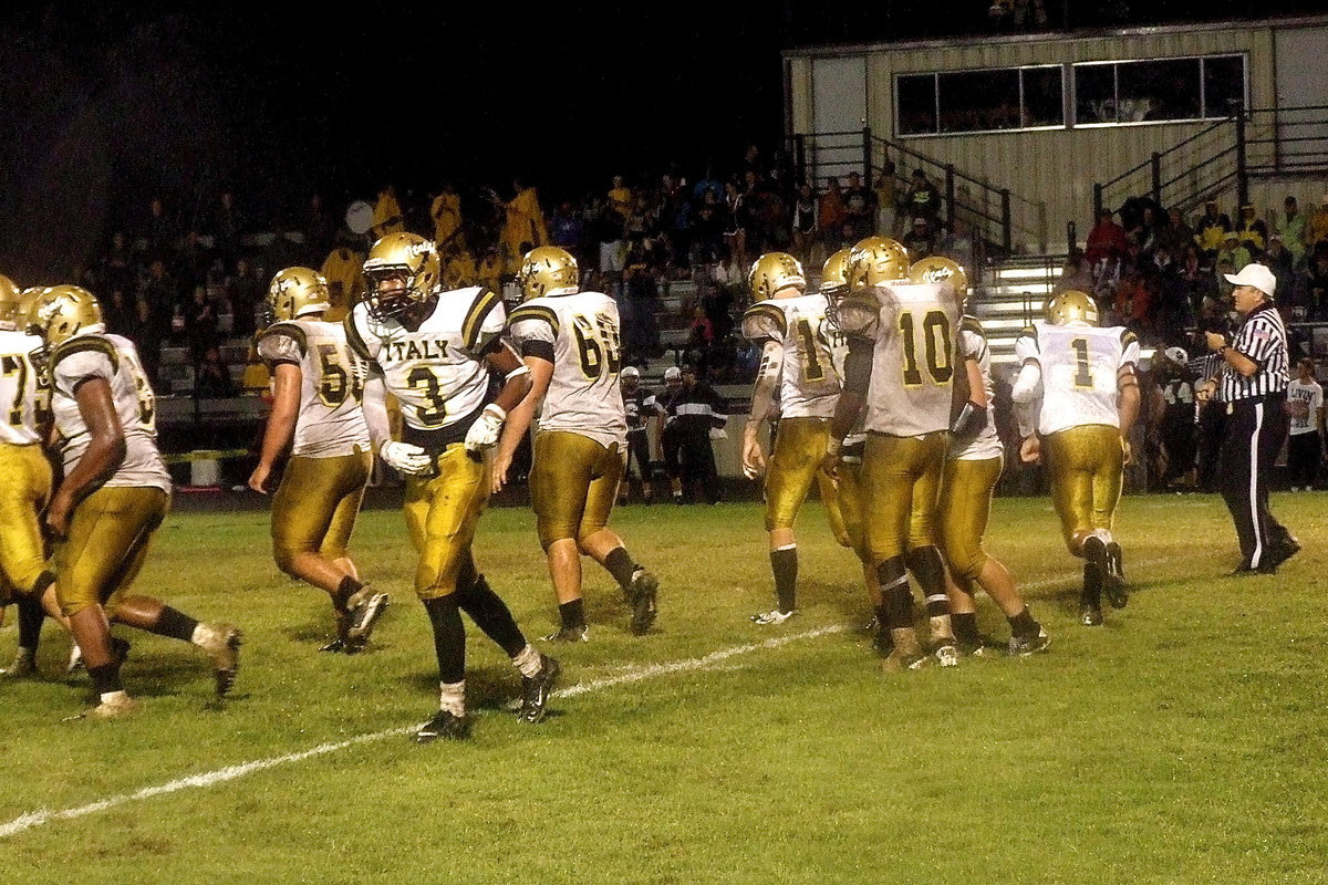 Image: The Gladiators break the huddle in the first half the “Mud Bowl” game, hoping to break Hubbard’s spirit.