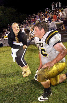 Image: Jaclynn Lewis poses with classmate John Byers(56) during the “Mud Bowl” game.
