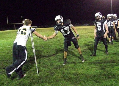 Image: Displaying sportsmanship, several Hubbard players walk over to congratulate injured Gladiator John Escamilla(12) and wish him well with Hubbard being affected by the injury bug themselves.