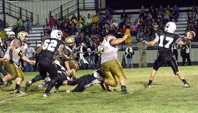 Image: Kevin Roldan(60), John Byers (56) and Zain Byers(50) try to put a little pressure on Hubbard’s quarterback to force an incomplete pass.