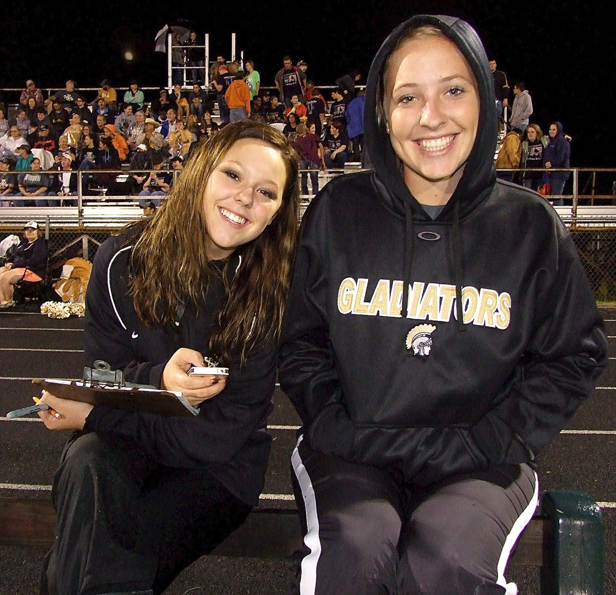 Image: There they are! Stat Squad girls Bailey Eubank and Jaclynn Lewis stay warm while staying on top of the game stats.