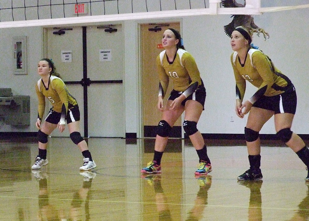 Image: Tara Wallis(5), Madison Washington(10) and Jaclynn Lewis(13) await a Lady Eagle serve.