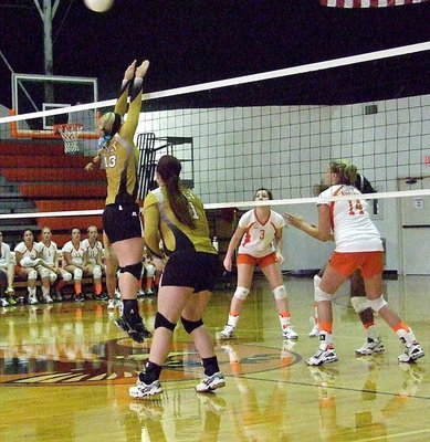 Image: Jaclynn Lewis(13) and Paige Westbrook(11) do work at the net.