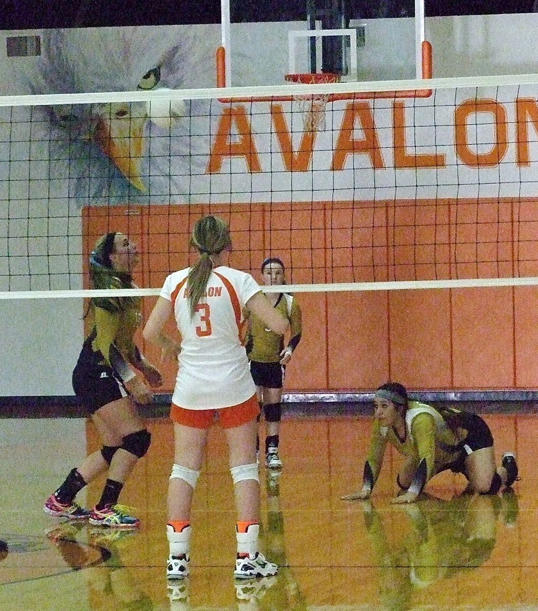 Image: Monserrat Figueroa(15) slides in to dig the ball up for her teammates.