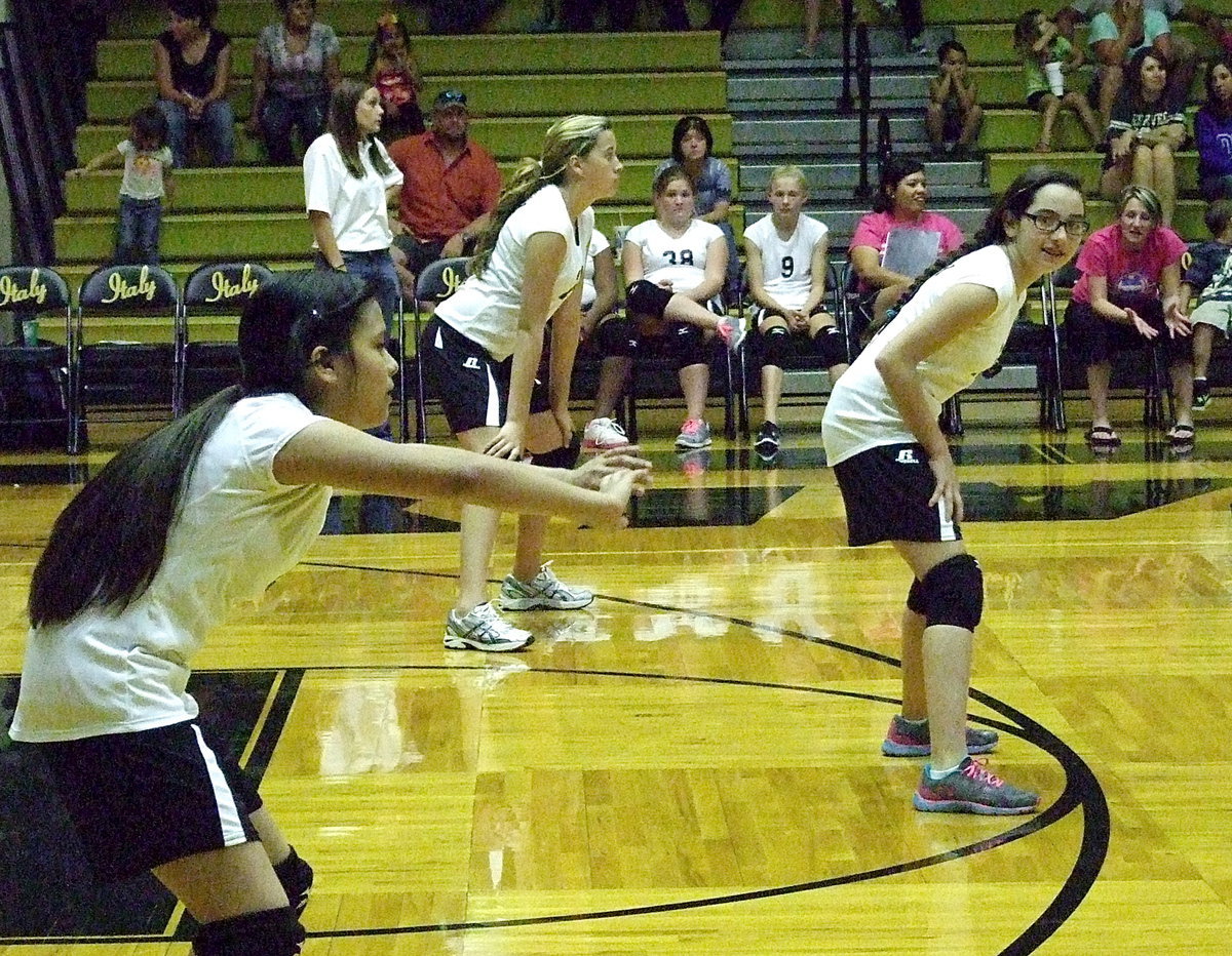 Image: Juliette Salazar(6), Hannah Haight(24) and Madison Galvan(10) prepare for an upcoming serve from Kopperl as Coach Morgan Mathews begs Madison to quit looking at the camera.