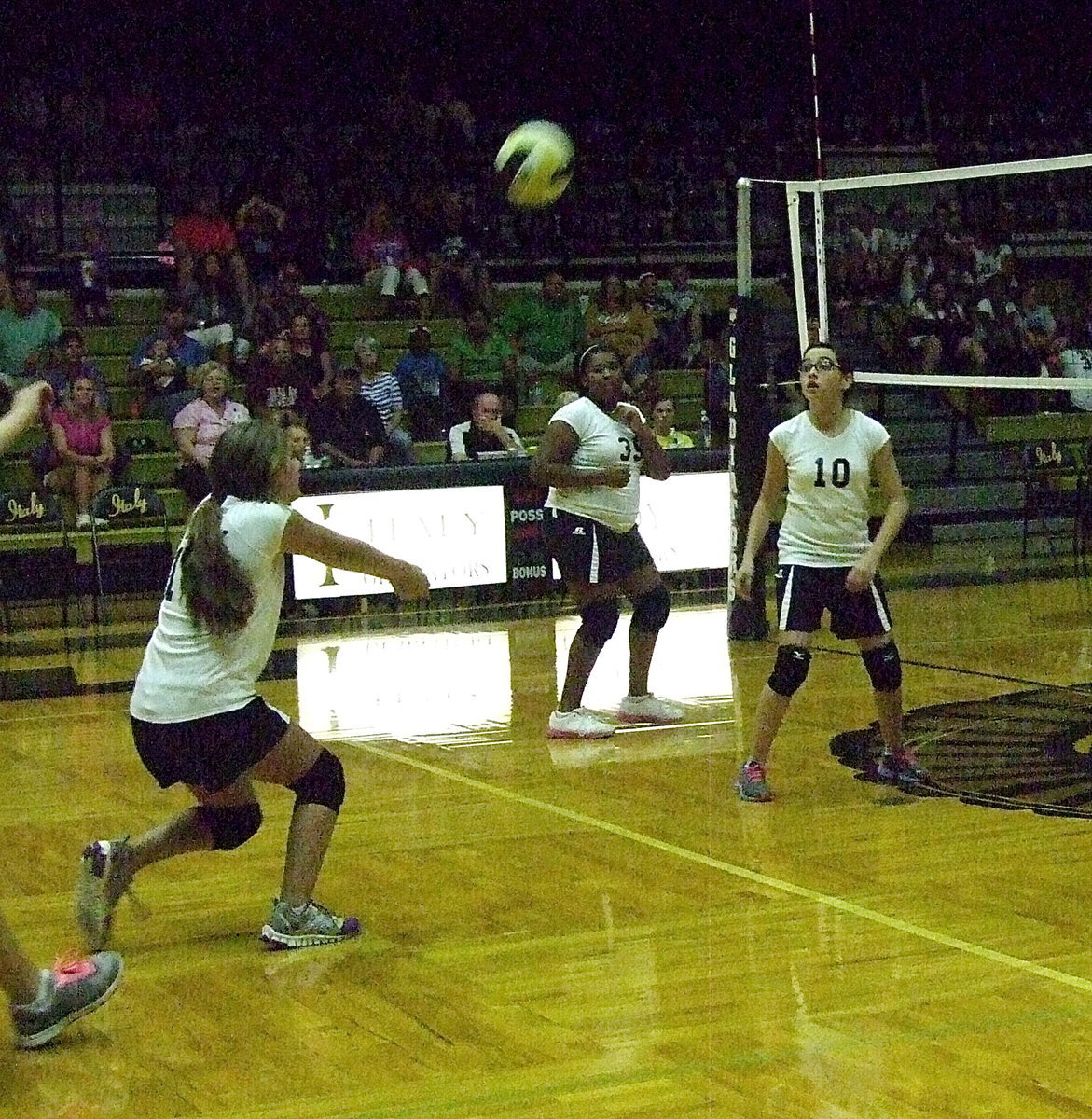 Image: Cassidy Gage(14) bumps the serve up as Jada Jackson(39) and Madison Galvan(10) react to the play.