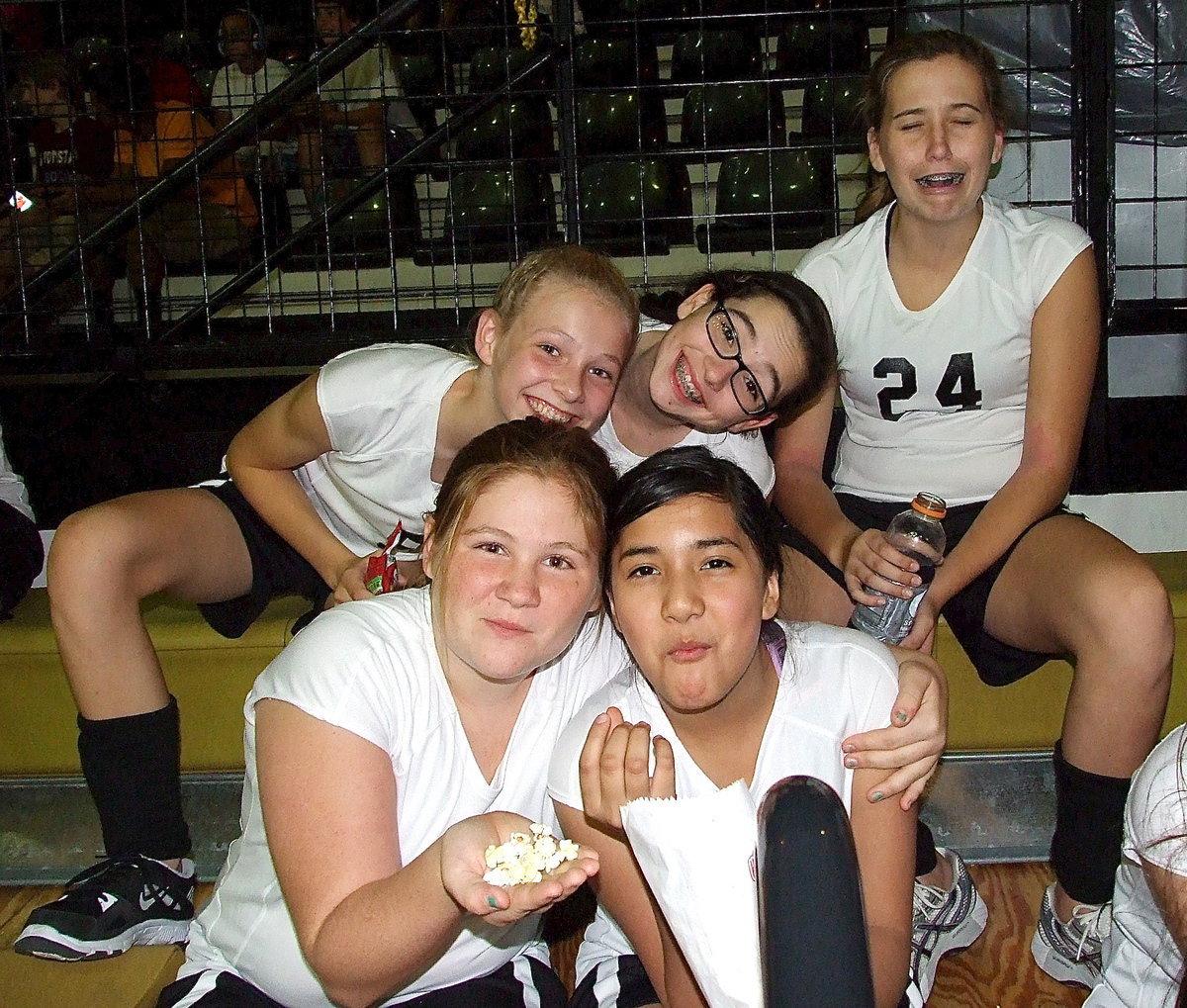 Image: Taylor Boyd(9), Madison Galvan(10), Hannah Haight(24) make due while Reagan Jones(38) and Emily Guzman(17) share popcorn.