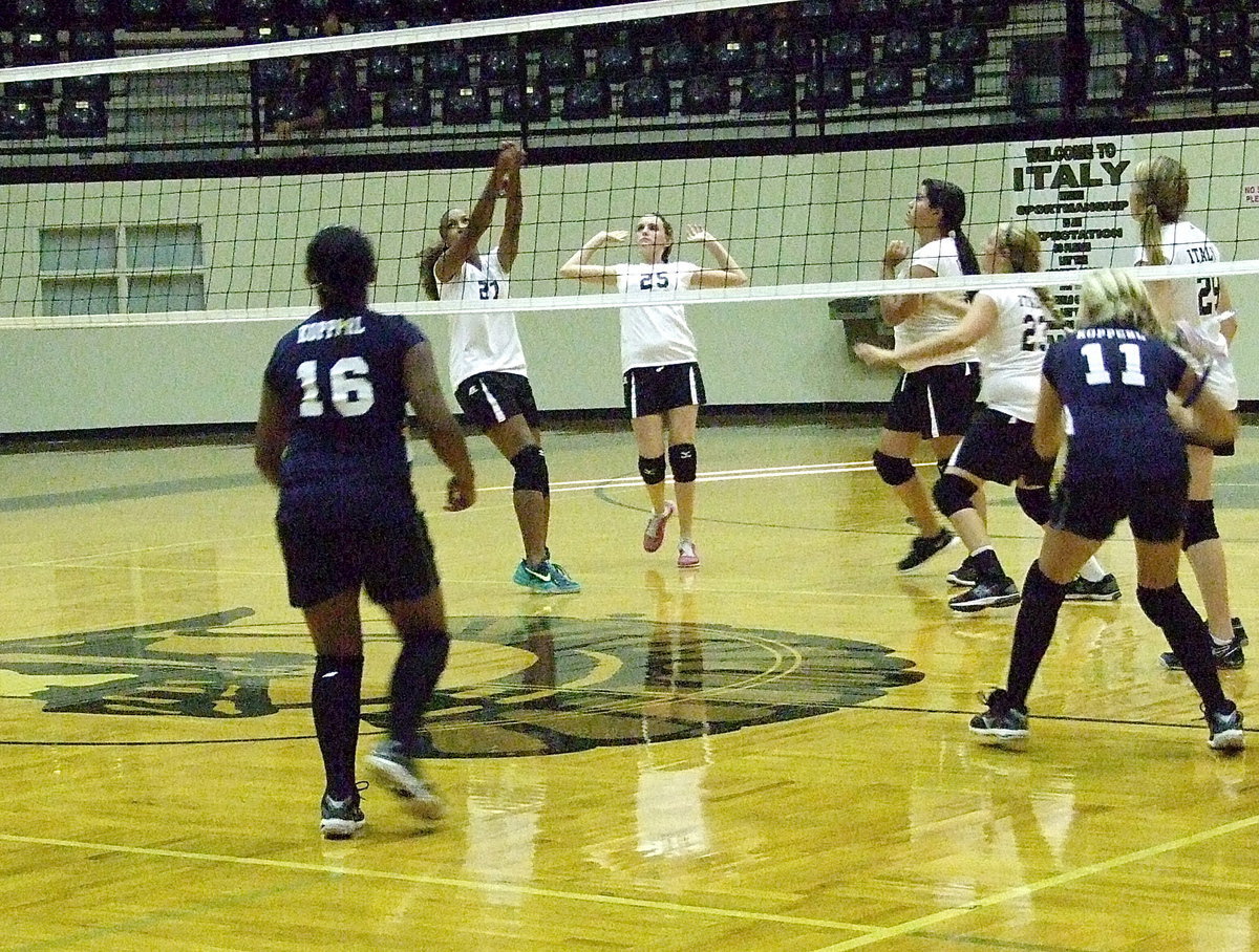 Image: Emmy Cunningham(27) bumps the ball over the net as Kirby Nelson(25) gives Cunningham room to work.