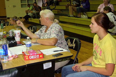 Image: Scorekeeper Rita Garza runs the show with help from Lady Gladiator Lillie Perry.