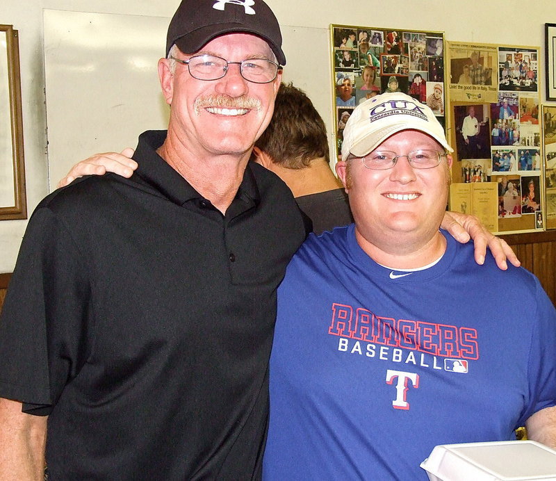 Image: Italy’s head football coach, Charles Tindol, and Defensive Coordinator, Brandon Gansky, stop the The Uptown Cafe to lend their support for the new camera before taking advantage of their bye week to scout upcoming opponents.