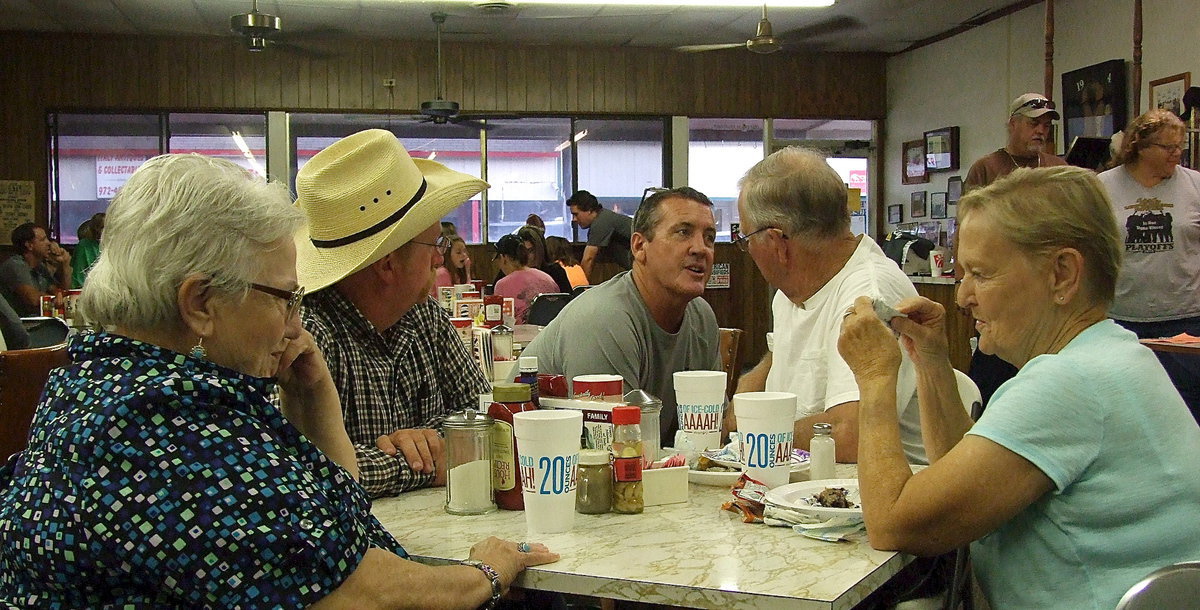 Image: Ann Byers, Brent Byers and Russ Lewis chat with Bob and Carla Pickard during the fundraising dinner.